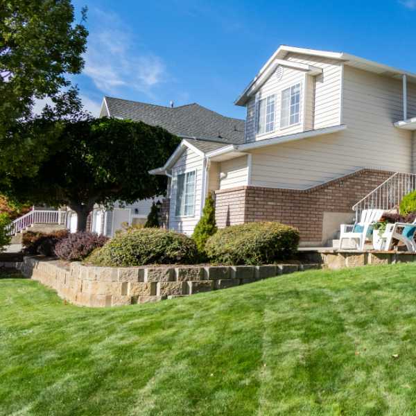 House with large block retaining wall